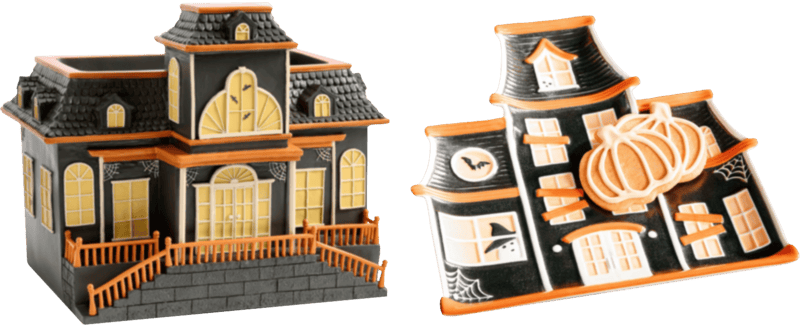 on the left a wider haunted house shaped container with an orange railing, on the right a ceramic tray in the shape of a haunted house, with two pumpkin-shaped cookies atop