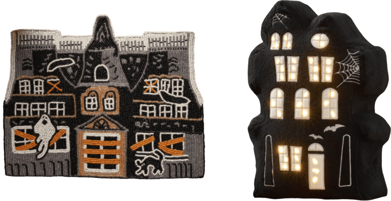on the left a haunted house beaded placemat in black and orange. on the right a black pillow, shaped like a haunted house, with embroidered bats and spiderwebs. the windows and door light up.