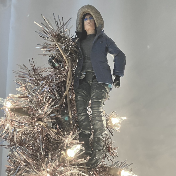 action figure of captain cold aka leonard snart posed atop an artificial christmas tree